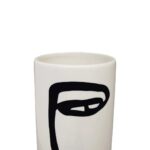 Large white ceramic vase with a cylindrical body and an abstract black face sketch for modern decor.