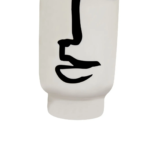 Small white ceramic vase with an abstract black face sketch, featuring a cylindrical shape and minimalist design.