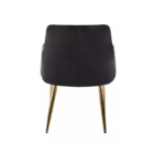 Black velvet dining chair with padded seat, quilted back, cocooning armrests, and gold splayed metal legs.