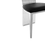Tall dining chair with a metallic back, black faux leather seat, and sleek tapered legs.