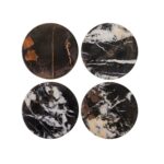 Set of four round black marble coasters with white veining, perfect for protecting surfaces in modern interiors.