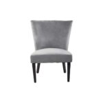 Grey velvet dining chair with a wingback design, deep-cushioned seat, black wood legs, and stud detail trim.