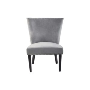 Grey velvet dining chair with a wingback design, deep-cushioned seat, black wood legs, and stud detail trim.