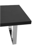 Modern dining table with a black elm wood rectangular top and U-shaped stainless steel legs for an industrial design.