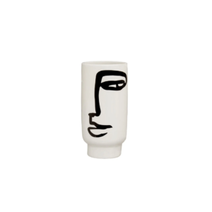 Small white ceramic vase with an abstract black face sketch, featuring a cylindrical shape and minimalist design.