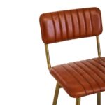 Tan leather barstool with vertical channel tufting and a sleek gold-finished angular iron frame.