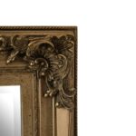 Classic wall mirror with carved motifs, weathered-effect frame, and vintage-inspired design, ideal for traditional or eclectic interiors.