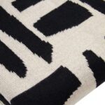 A stylish natural and black throw with a geometric tribal pattern, crafted from soft polyester for a cosy and modern home décor touch.