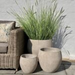 Set of three grey textured planters, ideal for indoor and outdoor plant displays.