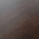 ELLIPS Dining Table – A mango wood dining table with a warm walnut finish, featuring a modern flattened-edge design.