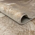 HELEN Rug with an abstract swirling pattern in warm browns and golds, crafted from polyester and polypropylene for comfort and durability.