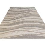 MARIE Rug – Elegant wave-patterned indoor/outdoor rug in soft greys, browns, and taupe, crafted from durable polyester.