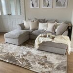 HELEN Rug with an abstract swirling pattern in warm browns and golds, crafted from polyester and polypropylene for comfort and durability.