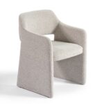 Modern dining chair upholstered in greyish bouclé fabric with a curved, architectural design and integrated arms.