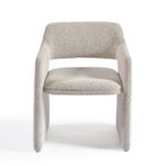 Modern dining chair upholstered in greyish bouclé fabric with a curved, architectural design and integrated arms.