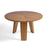Round light oak dining table with three-panel base – Helsinki design