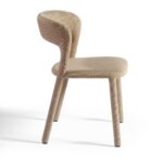 Taupe upholstered dining chair with curved backrest and minimalist design, perfect for modern or transitional dining spaces.