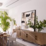Natural oak sideboard with slatted wood doors, gold metal base, and modern storage design.