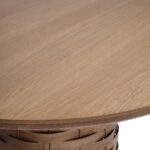 Round oak dining table with sculptural weaved pedestal base, made from natural oak wood with a distinctive design ideal for stylish dining rooms.