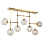 Elegant chandelier with antique gold frame and seven glass globes, perfect for modern dining rooms or statement ceilings.