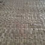 Square woven palm wall art in oak frame with light and dark brown tones, by Versmissen.