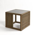 Natural oak side table with tempered glass top and slatted wood sides, designed for light-filled modern living spaces.