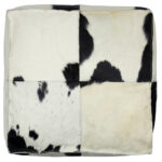 Black and white TAURUS cowhide pouf with natural pattern, ideal for modern and rustic interiors.