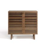 Natural wood small sideboard with slatted palillería doors and glass panels, standing on modern wooden legs.
