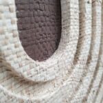 JULIE circular wall art with natural and dark brown woven palm in oak veneer frame by Versmissen.