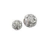 Pair of silver aluminium decorative spheres with cut-out pattern and polished finish.