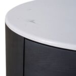 Elegant black oak bedside table with an oval design, stone top, and two drawers, combining natural warmth with contemporary style.