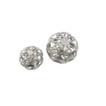 Pair of silver aluminium decorative spheres with cut-out pattern and polished finish.