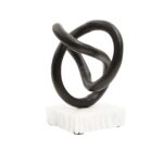 Matte black twisted knot sculpture on a raw-edged white marble base.