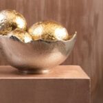 Large decorative bowl with silver and gold metallic finish in sculptural aluminium.