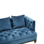 Three-seat navy Chesterfield-style fabric sofa with button tufting and gold-accented wooden legs.