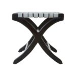 Teak wood stool with woven grey leather straps and black-stained scrolled legs, blending boho style with natural sophistication.