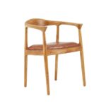 Brown leather chair with natural teak frame, open back, and curved armrests—featuring metallic stud accents for a timeless, handcrafted look.