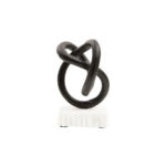 Matte black twisted knot sculpture on a raw-edged white marble base.