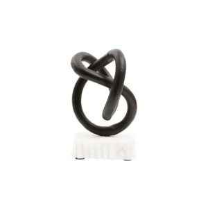 Matte black twisted knot sculpture on a raw-edged white marble base.