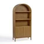 Tall natural oak display cabinet with rounded top, open shelving, and two-door lower storage.