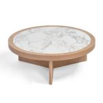 Round coffee table with light oak base and textured ceramic top, combining natural warmth with elegant simplicity.