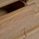 Natural oak sideboard with six drawers and gold metal legs, blending functional storage with modern elegance for contemporary interiors.
