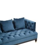 Three-seat navy Chesterfield-style fabric sofa with button tufting and gold-accented wooden legs.