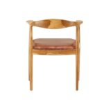 Brown leather chair with natural teak frame, open back, and curved armrests—featuring metallic stud accents for a timeless, handcrafted look.