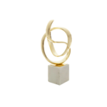 Gold knot sculpture on white marble base – elegant contemporary décor accent.