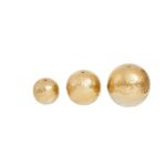 Set of three metallic gold and silver gradient decorative aluminium spheres.