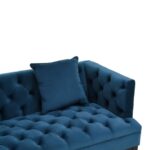 Two-seat navy fabric Chesterfield-style sofa with button tufting and gold-accented wooden legs.