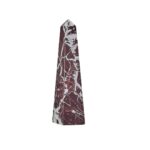Large red marble obelisk with white veining on a minimalist geometric form.