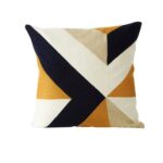 Square cushion with geometric embroidery in assorted tones, adding a bold, contemporary accent to any room.