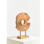 Mango wood ring sculpture with natural grain patterns, mounted on black iron rods and a matching wood base for a rustic-modern statement.